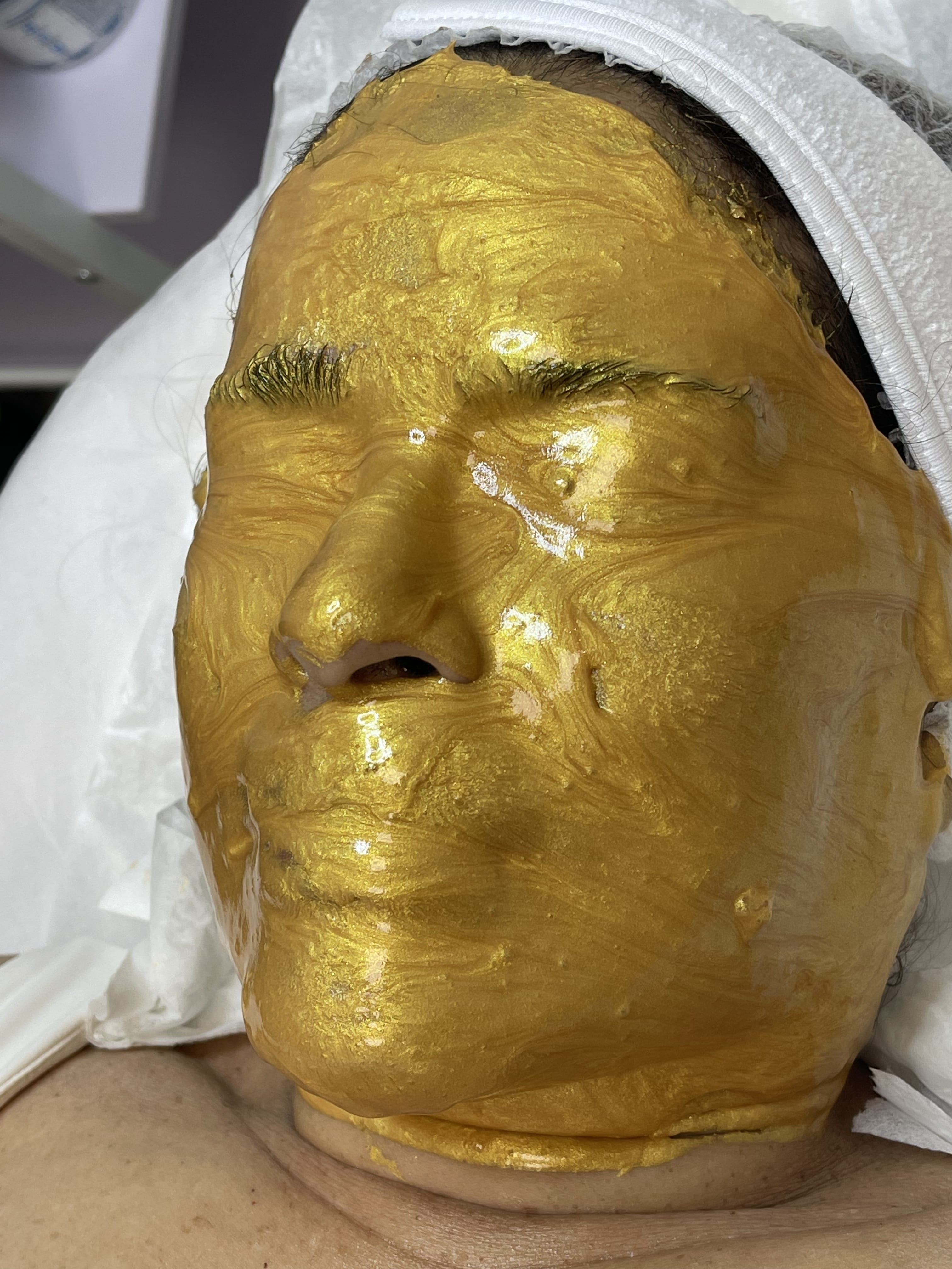 A woman wearing a golden mask 