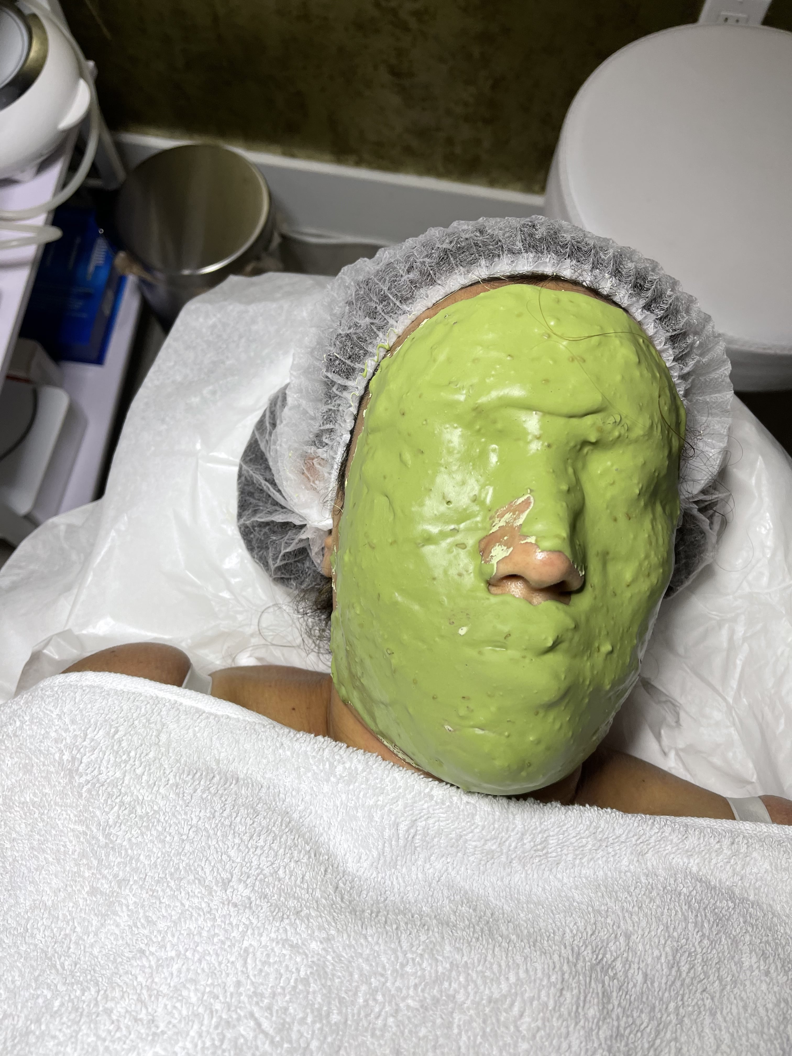 A woman wearing a green mask